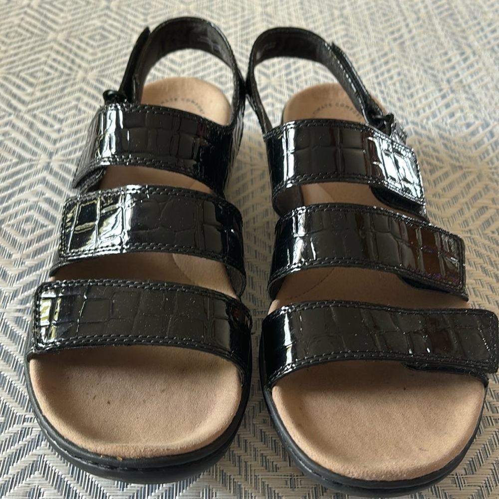 Woman’s black four strap sandal in size 9.